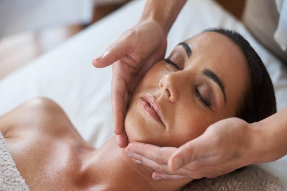 Woman receiving a relaxing facial massage at a spa
