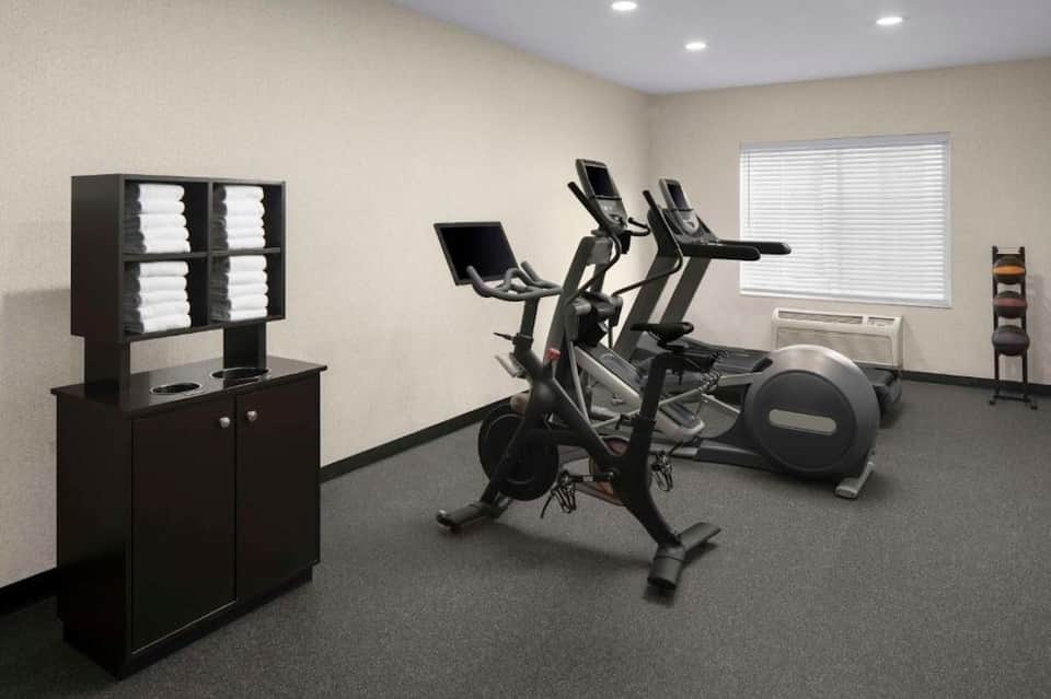 Fitness center with stationary bikes, elliptical machine, and exercise equipment
