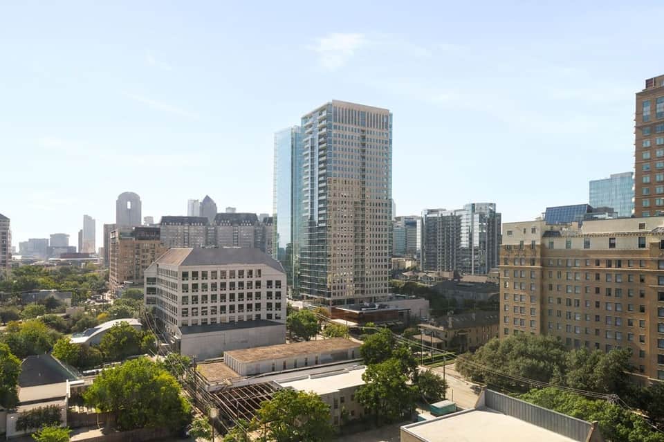 Urban downtown skyline view from high-rise residential tower overlooking city buildings
