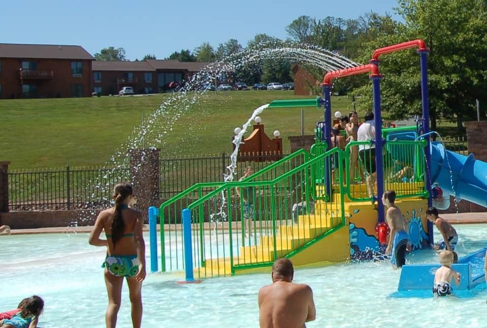 Colorful water play area with large dumping bucket splash feature and interactive water playground for children