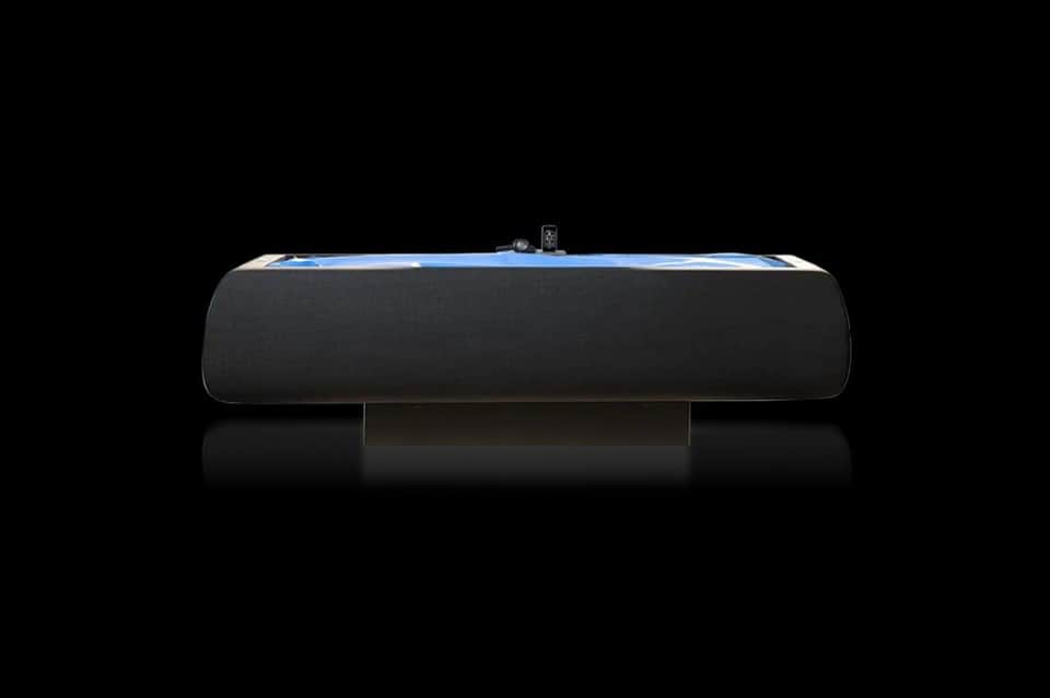 Sleek black and blue hydrotherapy bath tub against black background, product photography