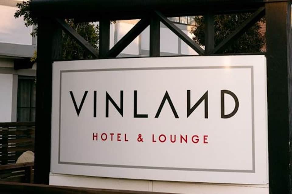 Vinland Hotel & Lounge exterior signage with black and white architecture
