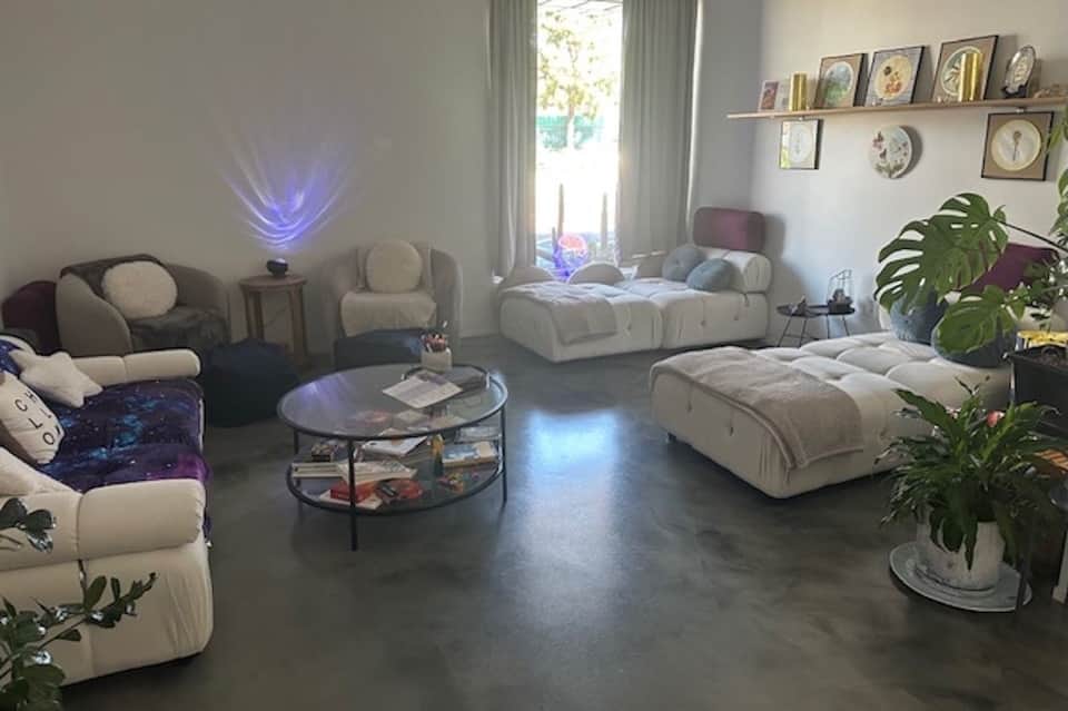 Modern living room with cream-colored modular furniture and blue accent lighting