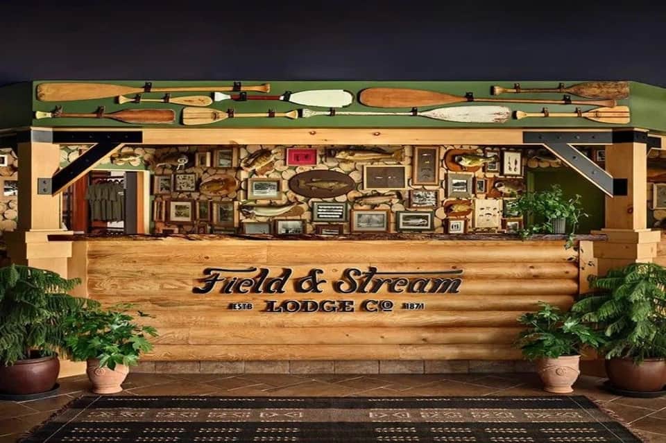 Field & Stream Lodge Co entrance with wooden signage, oars displayed above, and decorative elements