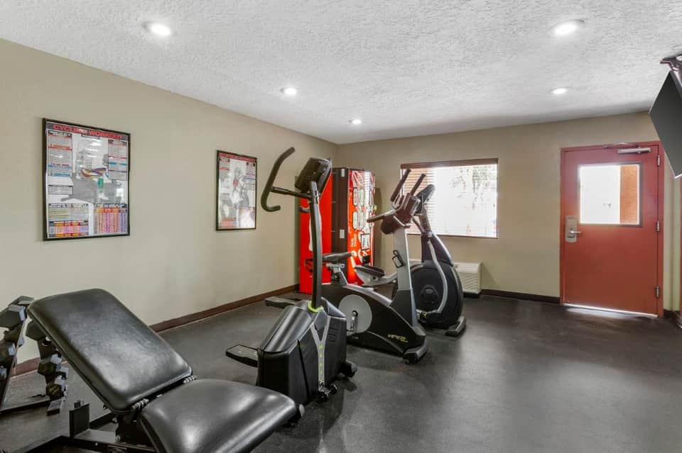 Hotel fitness center with exercise bikes, weight bench, and workout equipment