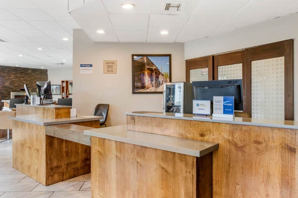 Hotel front desk reception area with wooden counter and check-in station