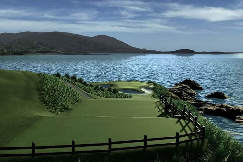 Scenic coastal golf course with green fairway overlooking blue water and mountains