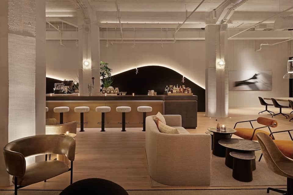 Modern lobby bar with curved black accent wall and contemporary seating furniture