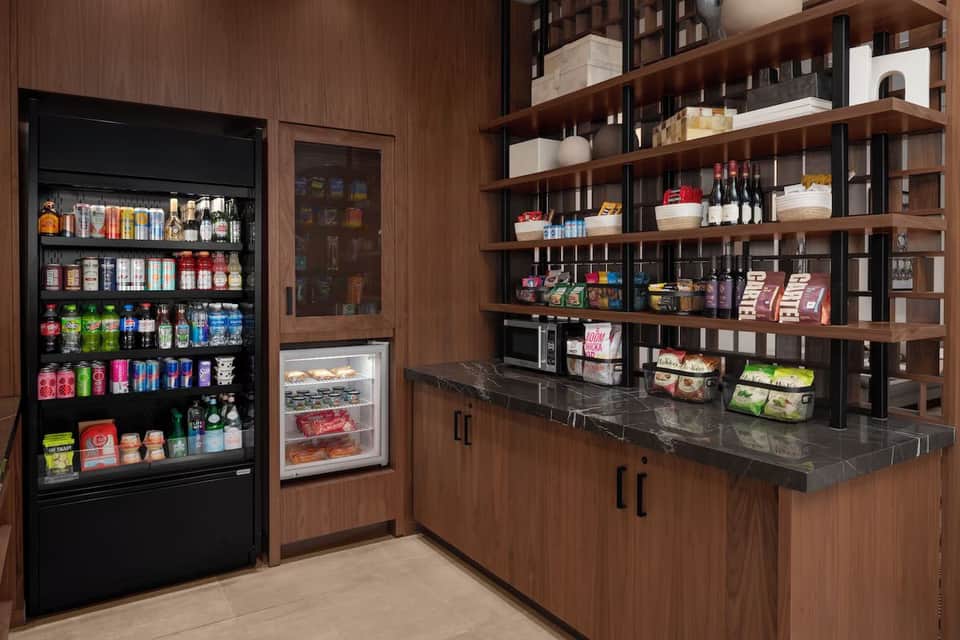 Convenience store with refrigerated displays, vending machines, and wooden shelving