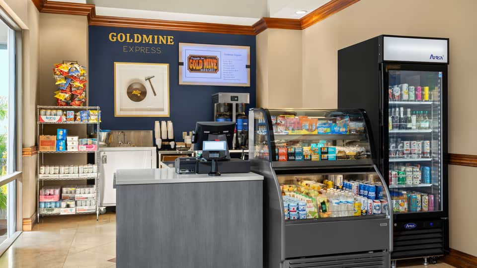 Goldmine Express convenience store interior with snack displays, refrigerated beverages and counter