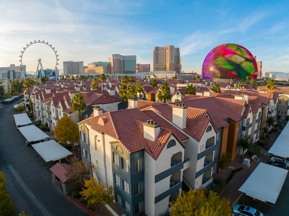 Aerial view of resort townhouses with Ferris wheel and Las Vegas skyline in distance