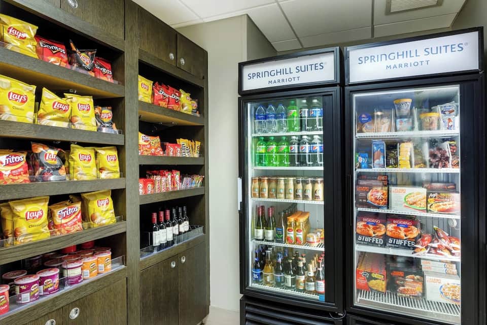 Hotel convenience shop displaying snacks, beverages, and frozen foods with Springhill Suites branding