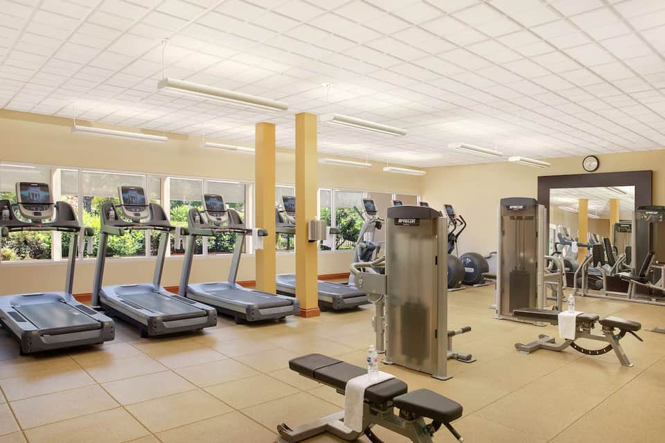 Fitness center with treadmills, exercise equipment, and large windows with natural light