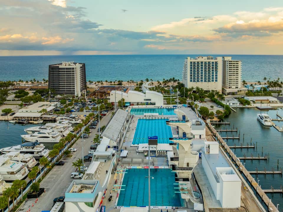 Overhead view of resort complex with Olympic pools, marina, and beachfront location