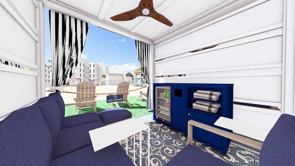 Modern cabana interior with blue accents, lounge seating, and ocean view