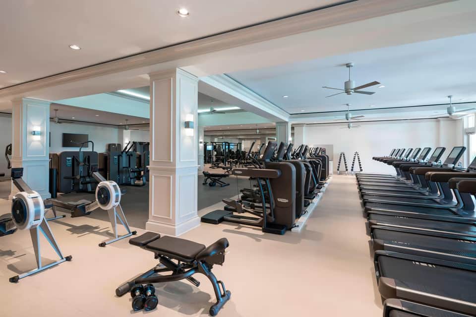 State-of-the-art fitness center with cardio equipment, strength machines, and modern lighting