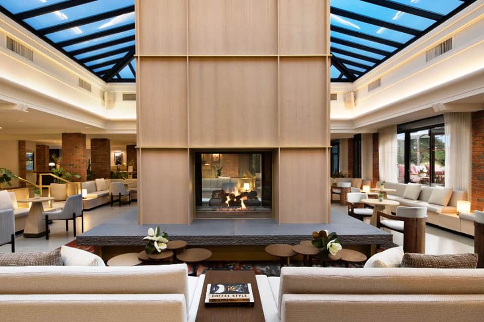 Contemporary living room with fireplace, skylights, and ocean-view windows