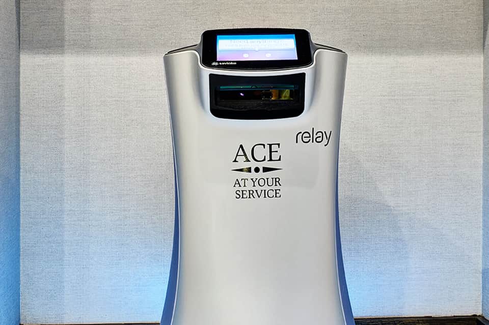 ACE relay device with digital screen and touchless interface mounted on wall