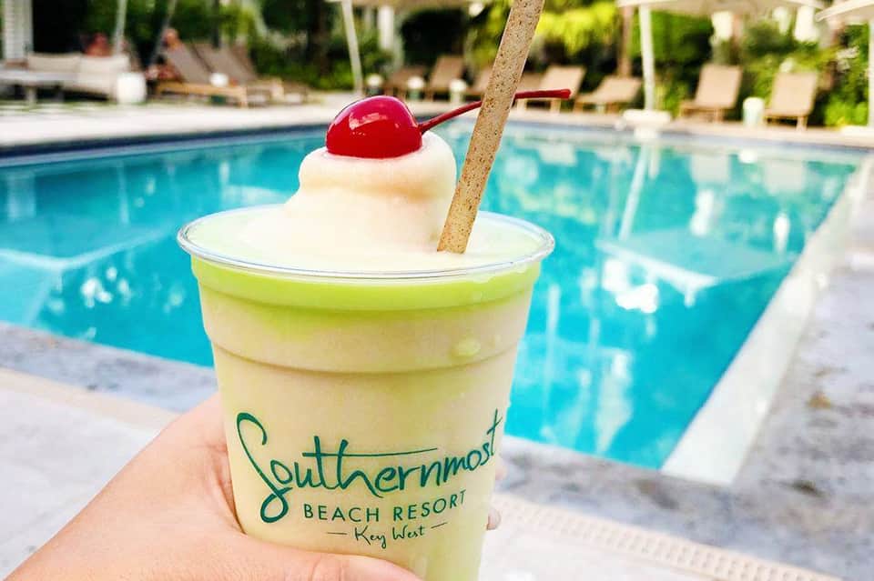 Frozen cocktail with whipped cream and cherry garnish by poolside at Southernmost Beach Resort Key West
