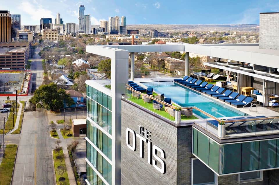 Rooftop pool at The Otis hotel with Austin skyline and surrounding cityscape in background
