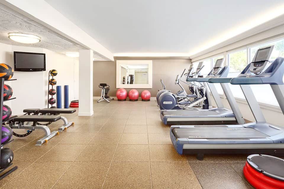 Modern fitness center with treadmills, exercise balls, and strength training equipment
