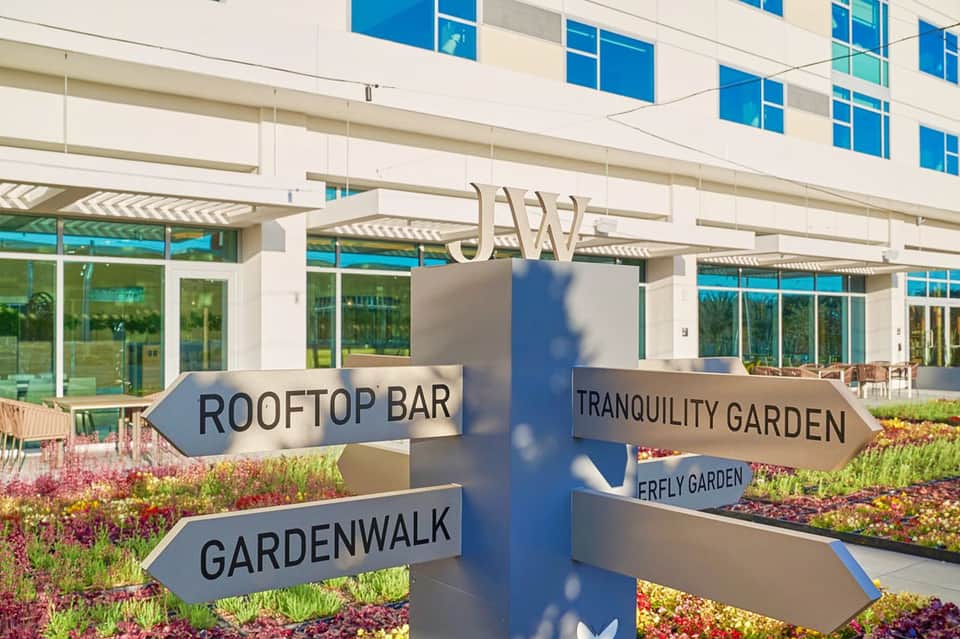 Directional signage pointing to rooftop bar, tranquility garden, and garden walk areas