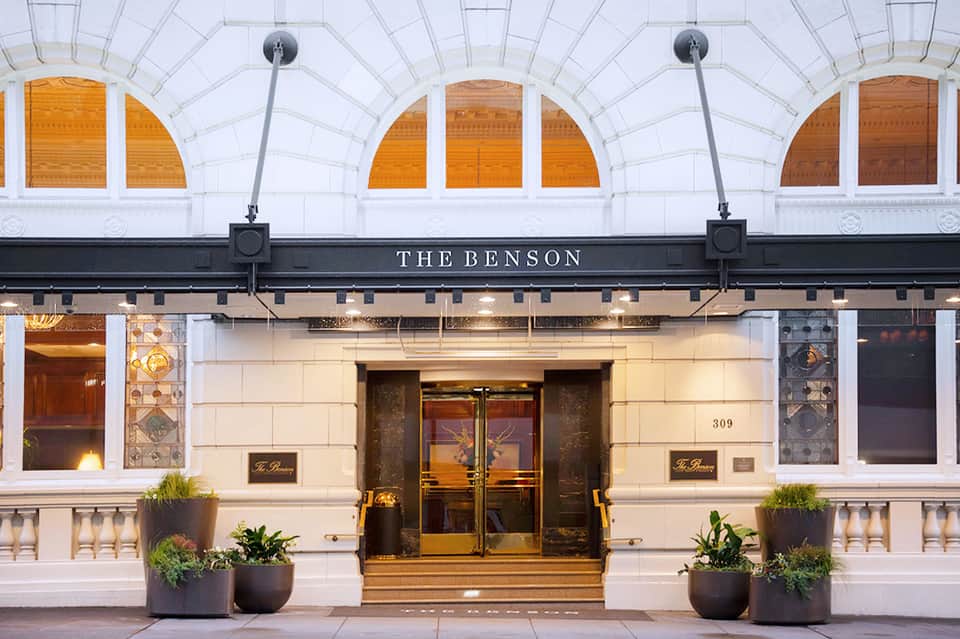 The Benson hotel storefront with arched windows, cream facade, and bronze doors