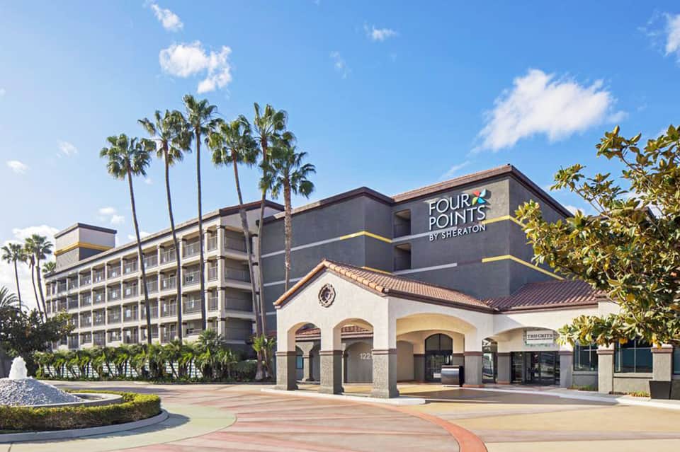Four Points by Sheraton hotel exterior with palm trees and modern architecture in daylight
