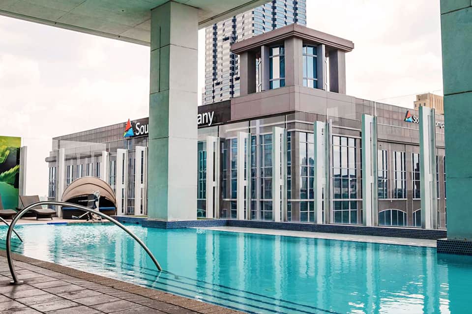 Indoor swimming pool with floor-to-ceiling windows and modern building architecture