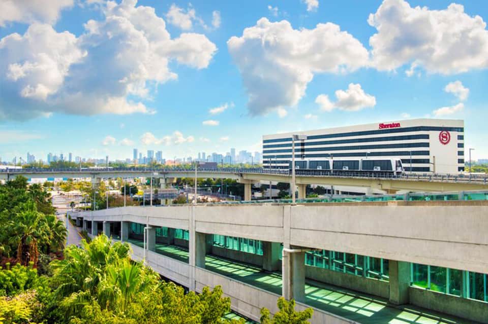Sheraton Hotel exterior view showcasing modern architecture with city skyline visible in the background