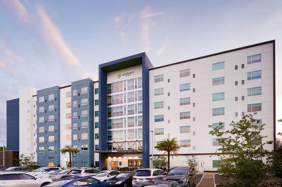 Element hotel contemporary architecture with white and blue facade, palm trees