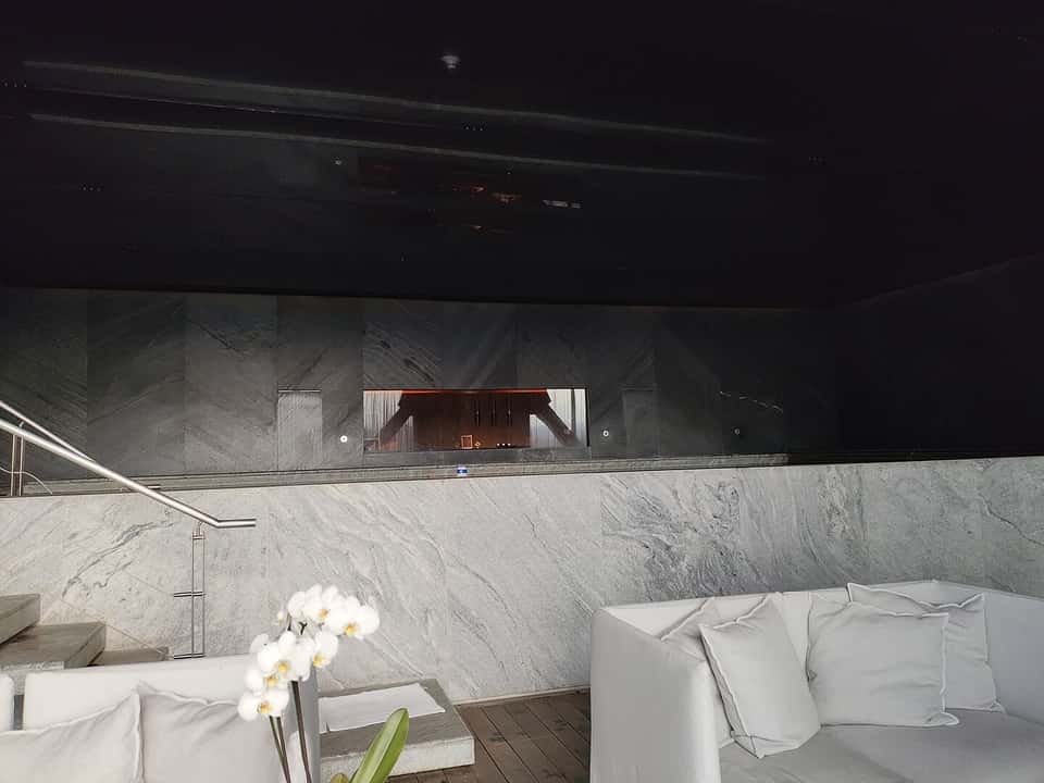 Luxury spa treatment room with massage table, floor-to-ceiling