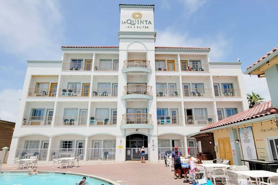 La Quinta Inn & Suites white building facade with multiple balconies and small pool area