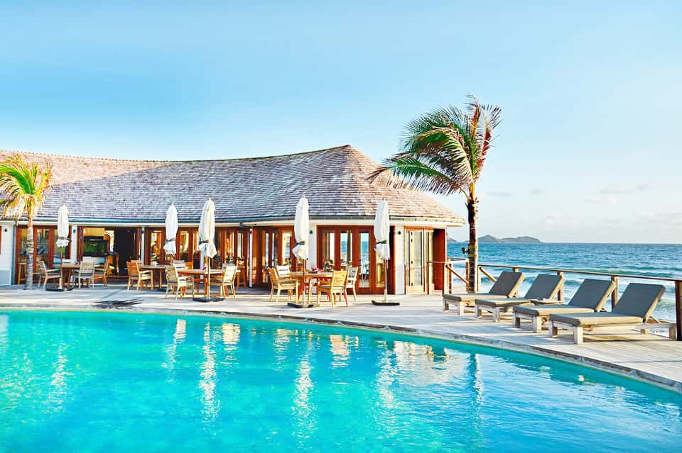 Luxury beachfront resort with pool, cabanas, and ocean view