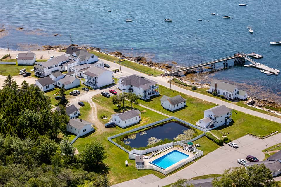 Coastal residential community with white cottages, boats, and waterfront docks