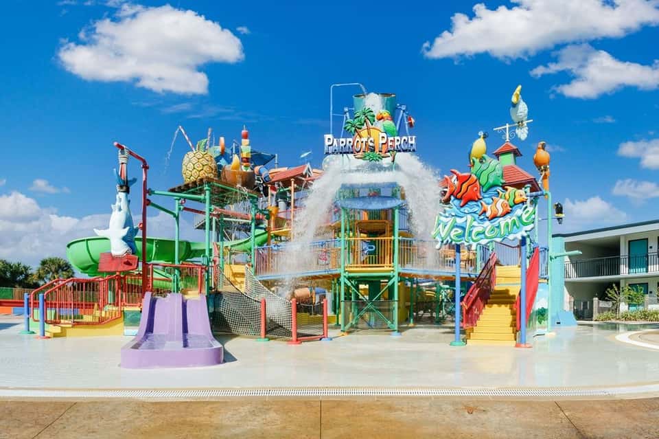 Parrot-themed water park attraction with colorful slides, splash features, and whimsical designs