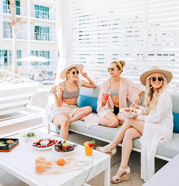 Women eating brunch in a private cabana at a resort